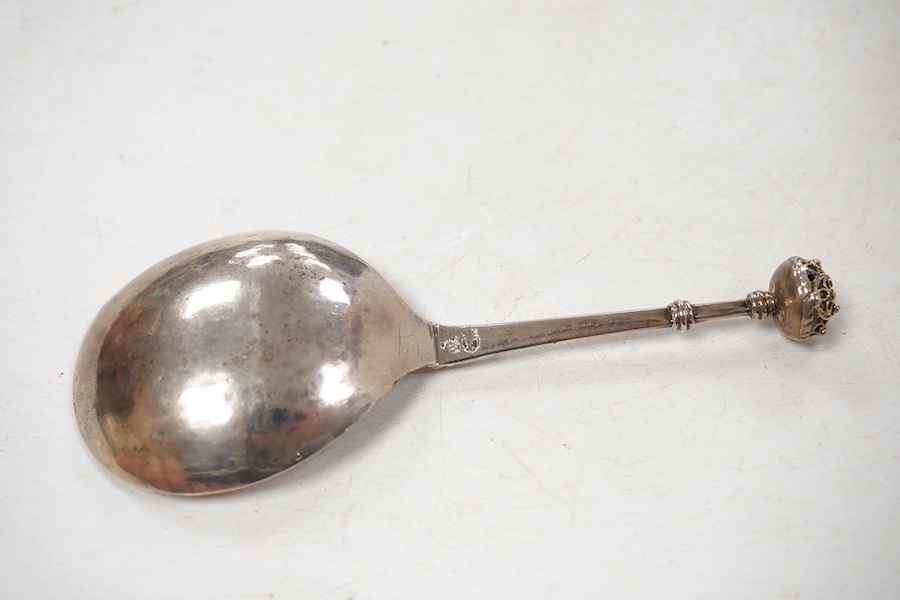 A late 18th/early 19th century Swedish? white metal spoon, with pierced parcel gilt finial, indistinct marks on the stem, 15cm.